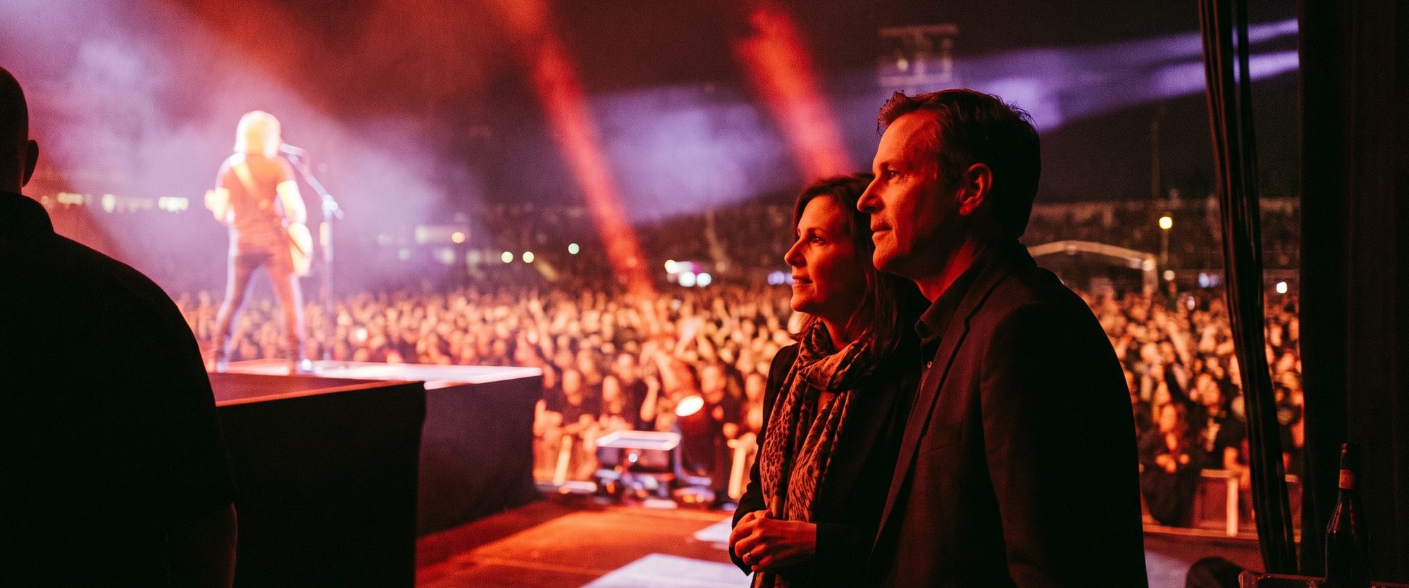 Members watching a performance from the side of the stage.